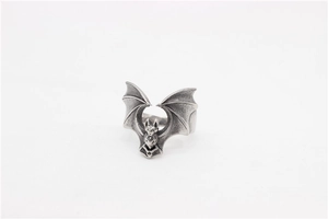 Macro detail of retro stainless steel bat wing ring with gothic oxidized metal finish