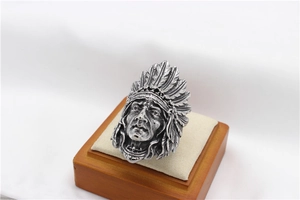 Detailed view of vintage silver Indian chief head ring with engraved feather texture