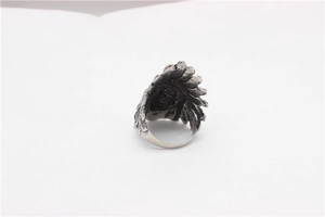 Detailed close-up of vintage steel ring featuring an intricate Indian chief feather design