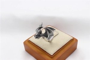 Macro detail of gothic bat ring in vintage steel finish on a velvet jewelry display