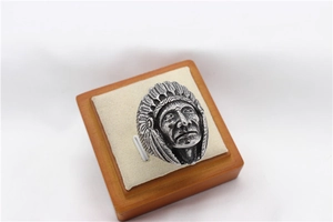 Macro detail of vintage steel ring featuring intricate Indian chief head carving