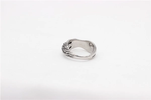 Close-up of vintage steel ring featuring detailed flame texture and retro silver finish