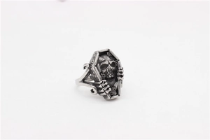Detailed macro view of vintage gothic skull coffin ring made of aged titanium steel