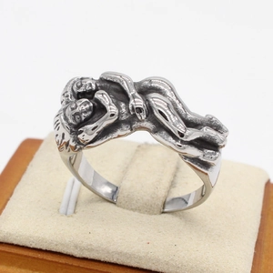 Vintage style hugging hands stainless steel ring with antique silver finish on a display