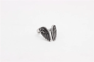 Close-up of vintage titanium steel ring featuring detailed angel wings and oxidized silver finish