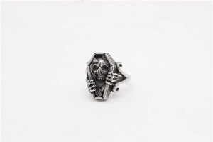 Macro view of gothic coffin ring featuring detailed skull and floral engravings inside