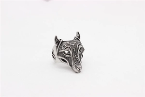 Close-up of vintage wolf head steel ring with intricate Celtic knot engraving