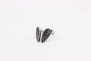 Macro detail of retro stainless steel angel wing ring with vintage oxidized finish