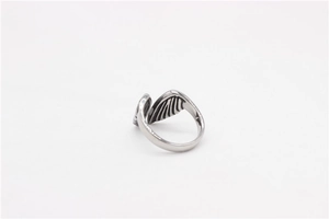 Close-up macro view of vintage silver steel wing ring with detailed feather texture