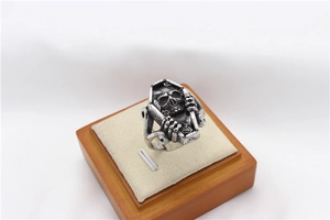 Macro view of vintage stainless steel coffin ring with skull and bone claw details