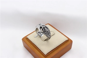 Detailed relief of the Medusa style vintage silver ring on a professional jewelry display