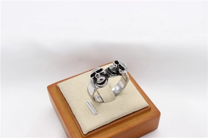 Close-up of double skull stainless steel ring with vintage black finish on jewelry stand