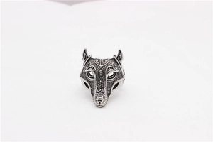 Macro detail of Nordic Viking wolf head ring with intricate Celtic knot patterns