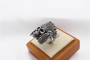 Macro view of retro stainless steel skull ring with detailed Indian feather carvings