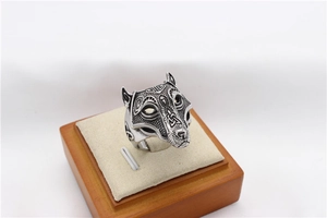 Detail of vintage wolf head ring with intricate Celtic patterns in matte silver finish
