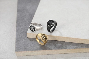 Macro detail of three-piece vintage maple leaf cutout rings in silver, black and gold finish