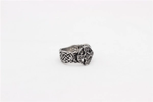 Close-up of vintage steel cross ring with Celtic knot patterns and black center stone