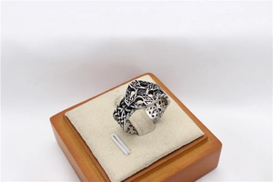 Macro view of vintage steel cross ring with black gemstone and Celtic weave details