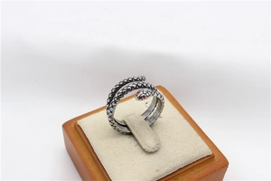 Detailed view of vintage steel snake ring with red crystal eyes and scale texture