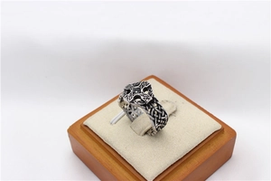 Macro view of vintage titanium steel ring with Celtic knot and black zircon center