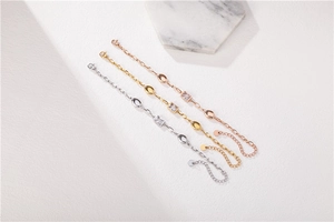 Detailed macro view of three adjustable titanium steel bracelets in silver, gold, and rose gold