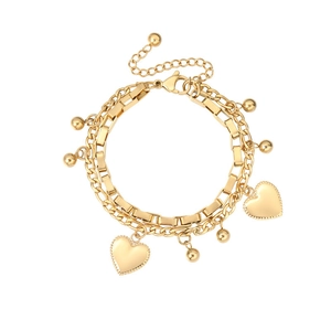 Detail of a double-layered gold heart pendant bracelet with square and round chains