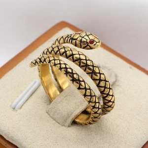 Vintage gold snake ring for men in coiled stainless steel with red gemstone eyes