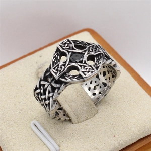 Vintage silver steel ring featuring a black gemstone and Celtic cross engraving