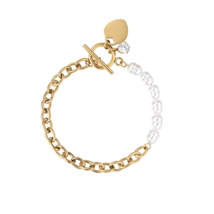 Detail of gold chain bracelet featuring irregular pearls and a heart pendant with OT toggle