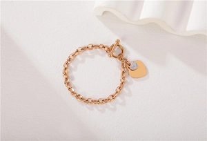 Macro detail of rose gold heart bracelet featuring a toggle clasp and zirconia stones