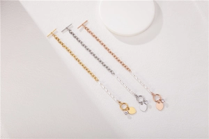Close-up of toggle clasp and heart charm on mixed chain and pearl bracelet