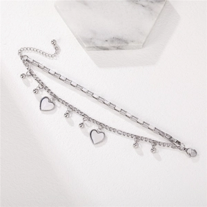 Double-layered stainless steel heart bracelet with beads and lobster clasp on white background