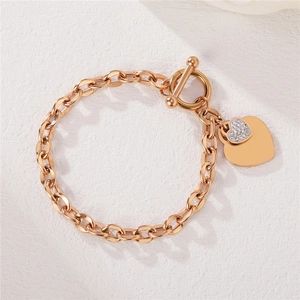 Rose gold heart bracelet with pavé stones and OT toggle clasp on textured background