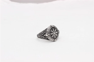 Detailed macro of vintage Viking Vegvisir ring with intricate skull and totem engravings