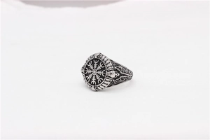 Detailed view of vintage viking compass ring with skull relief in stainless steel