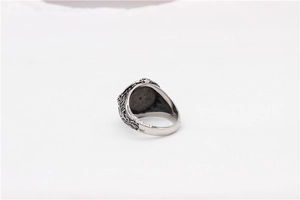 Close-up of vintage Viking Celtic knot patterns on a rustic silver titanium steel ring