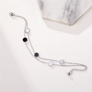 Elegant double-layered silver titanium bracelet with black and white shell charms