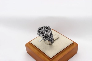Macro detail of Viking Vegvisir compass ring with side skull carvings in vintage steel finish