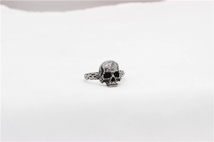 Detailed close-up of retro skull ring featuring a hammered texture on vintage steel
