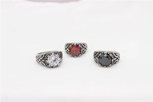 Detail view of retro titanium steel rings with vine relief and colorful gemstones