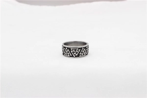 Macro shot of Viking Valknut symbol on retro stainless steel ring with black oxidation finish