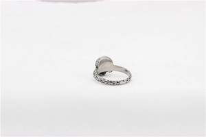 Macro shot of silver titanium ring with vintage hammered lava texture and smooth finish
