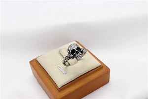 Close-up detail of vintage silver skull ring with gothic punk oxidized metal finish