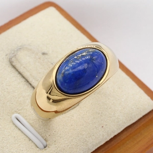 Elegant gold lapis lazuli ring with oval gemstone on polished stainless steel band