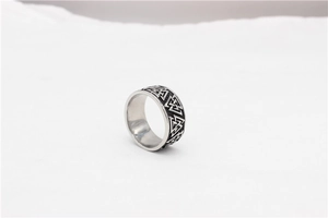 Macro detail of Nordic Viking Valknut symbol embossed on vintage steel ring