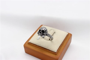 Detail view of vintage skull ring with hammered texture and realistic bone carvings