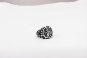 Macro detail of silver vintage Caesar relief ring with intricate side texture