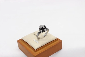 Macro shot of gothic skull ring detail with vintage oxidized finish and textured band