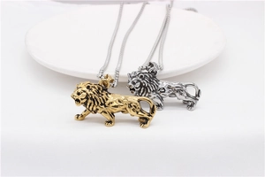 Detailed view of gold and silver lion pendants showing fine craftsmanship and textures