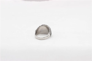 Detailed side view of silver metal ring with embossed braided textures on the band